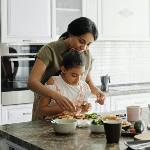 Mom and daughter preparing food