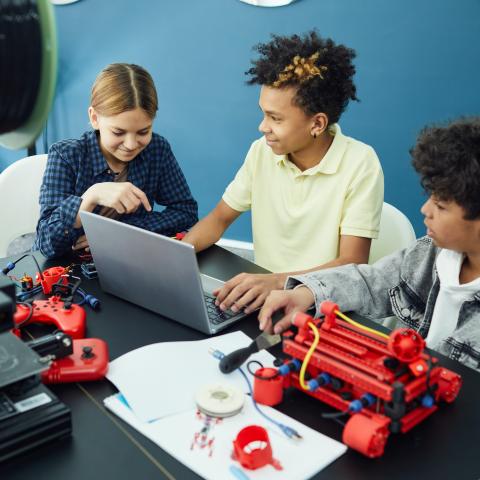 group of teens working on computer