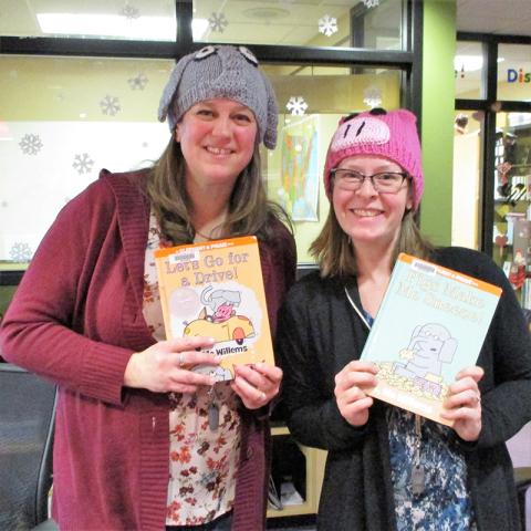 Two women holding Elephant & Piggie books