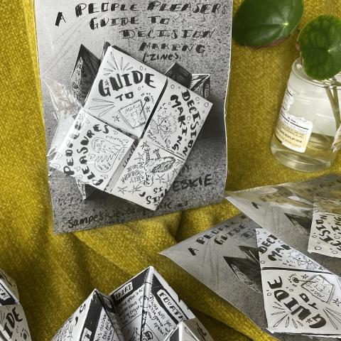 Picture of a zine cover and folded zines