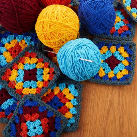 Crocheted squares and yarn