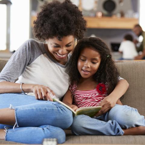 Mom and daughter reading on couch