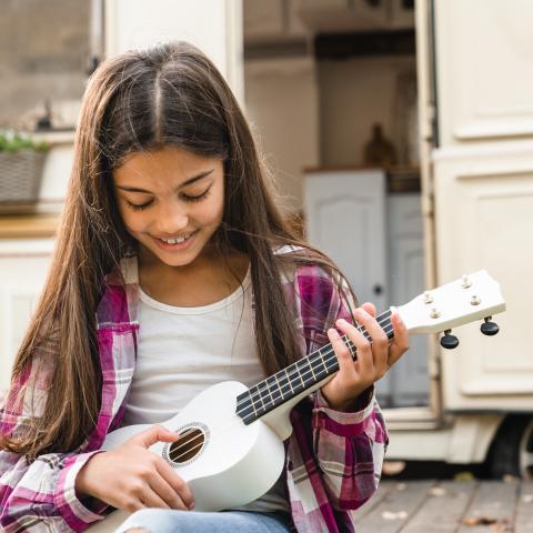 Smiling girl with ukulele