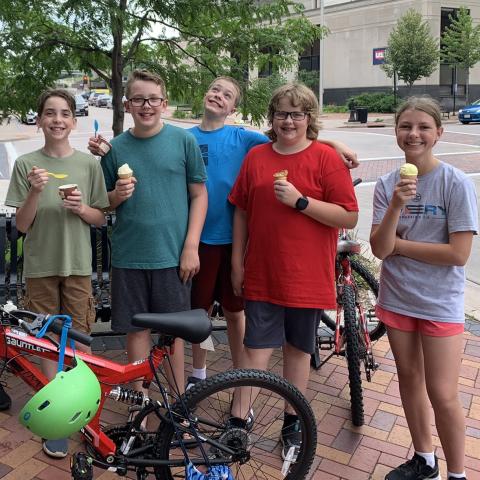 Group of teens behind a bike