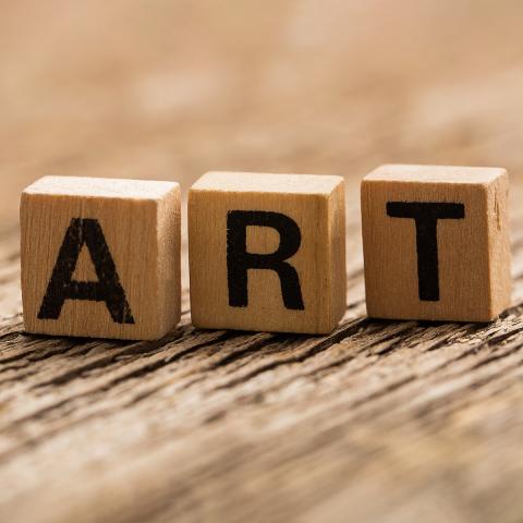 The word "ART" written in Scrabble titles.