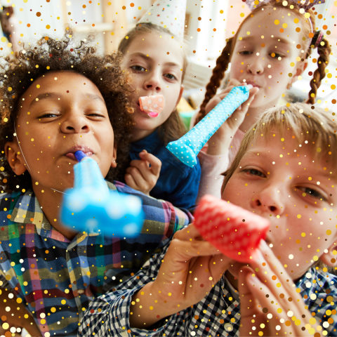 Children blowing noise makers