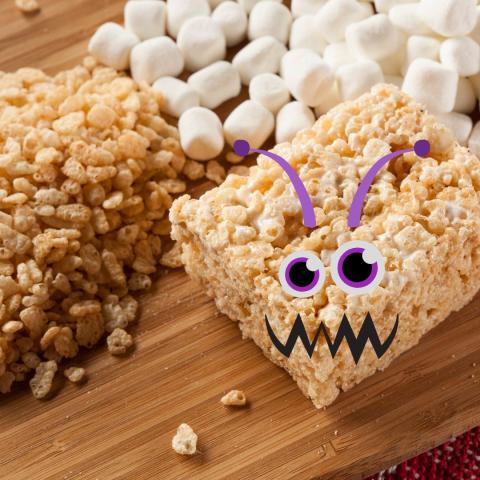 Piles of marshmallows and Rice Krispies cereal, plus a square Rice Krispies Treat with monster eyes, mouth, and ears.