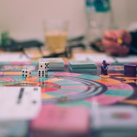 Photo of a man's hand moving a game piece