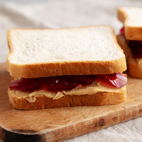 photo of a peanut butter and jelly sandwich on a cutting board