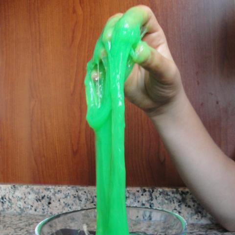 Hand holding green slime