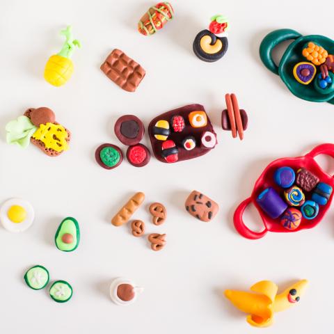 A photograph of tiny assorted foods made out of clay. 