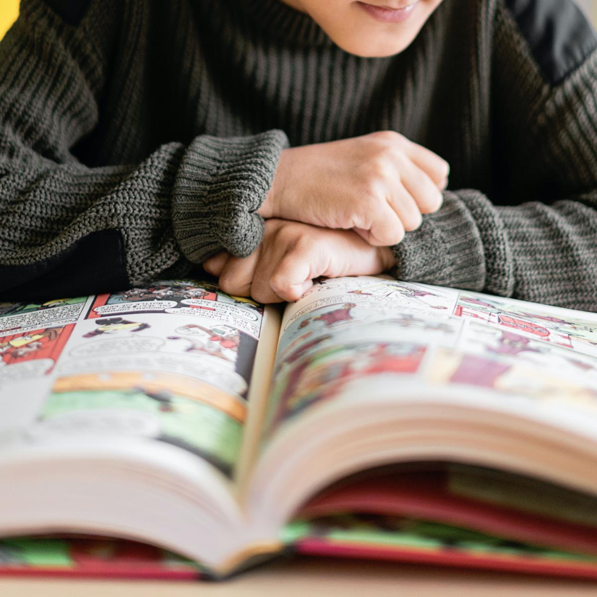 Teen reading graphic novel