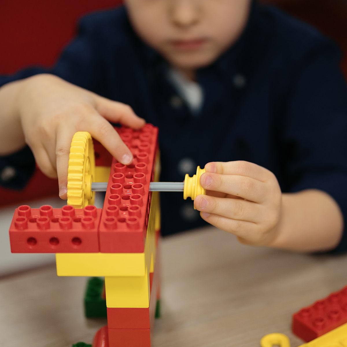 Child building with LEGOs