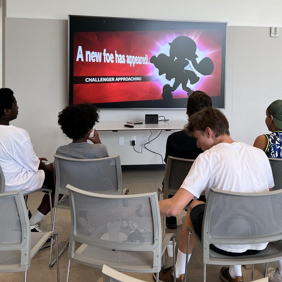 Group of teens sitting in front of TV