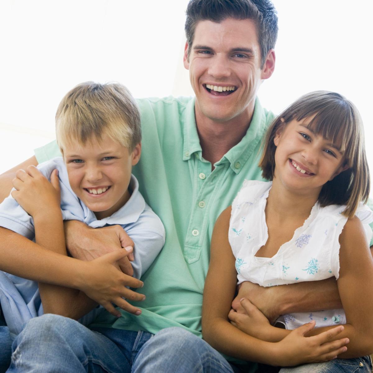 Man with two children, smiling