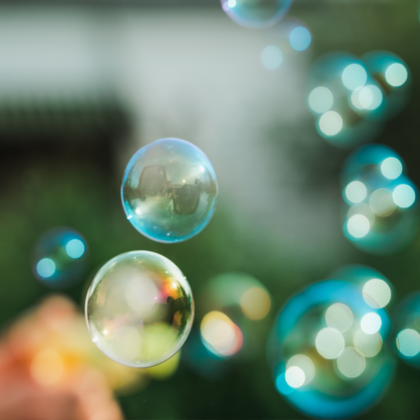 A close-up photograph of bubbles floating in the air.