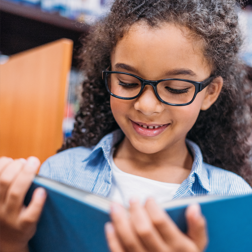 A photograph of a child reading.