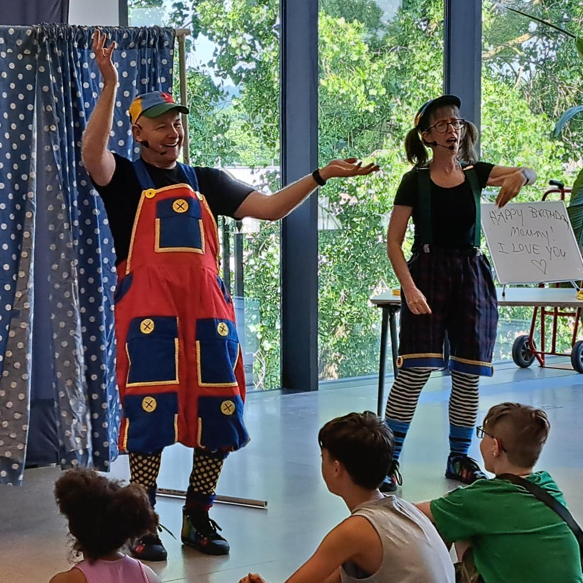 A man and woman standing in front of a crowd.