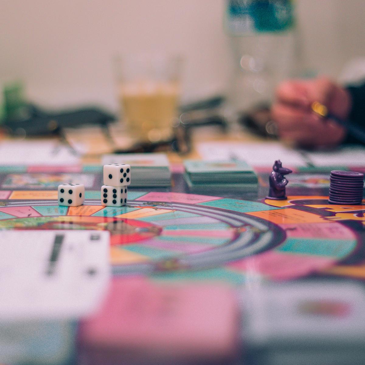 Photo of a man's hand moving a game piece