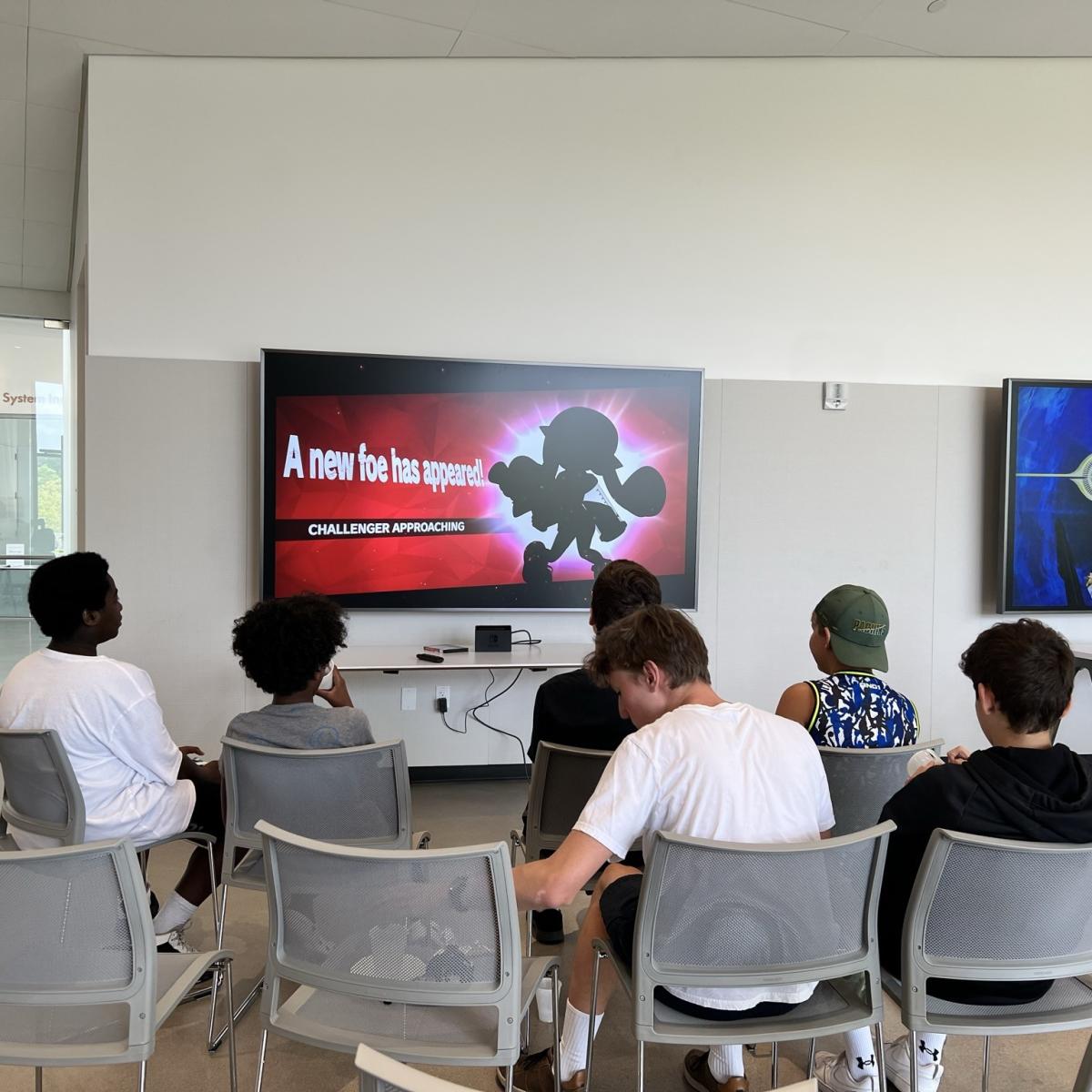 Group of teens playing Nintendo Switch. 