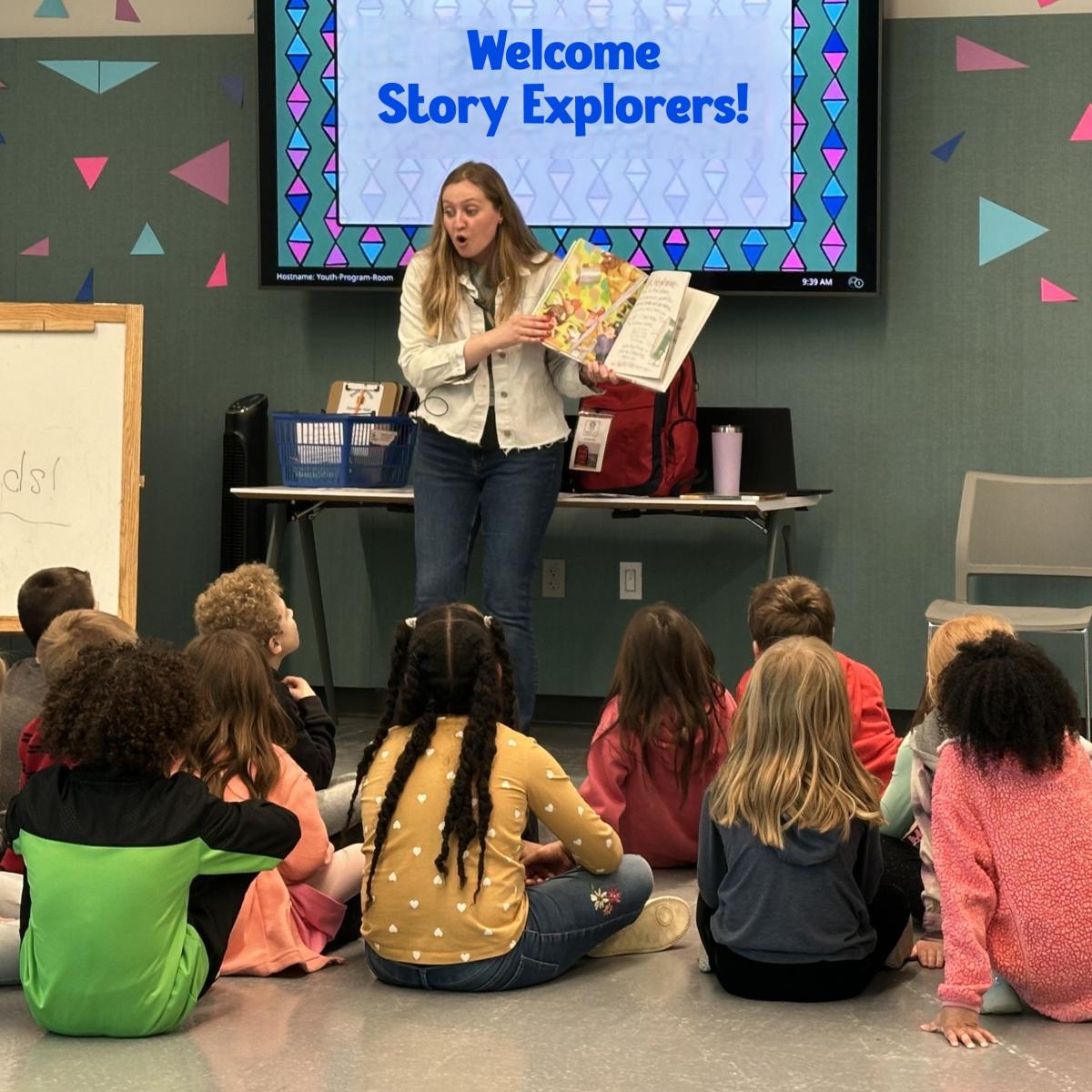 A woman is reading a book to a group of children