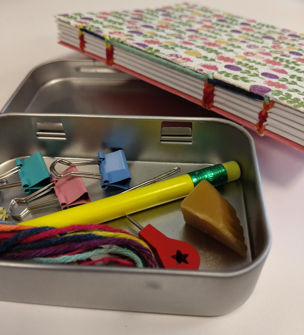 Picture of a pocket-sized bookbinding toolkit