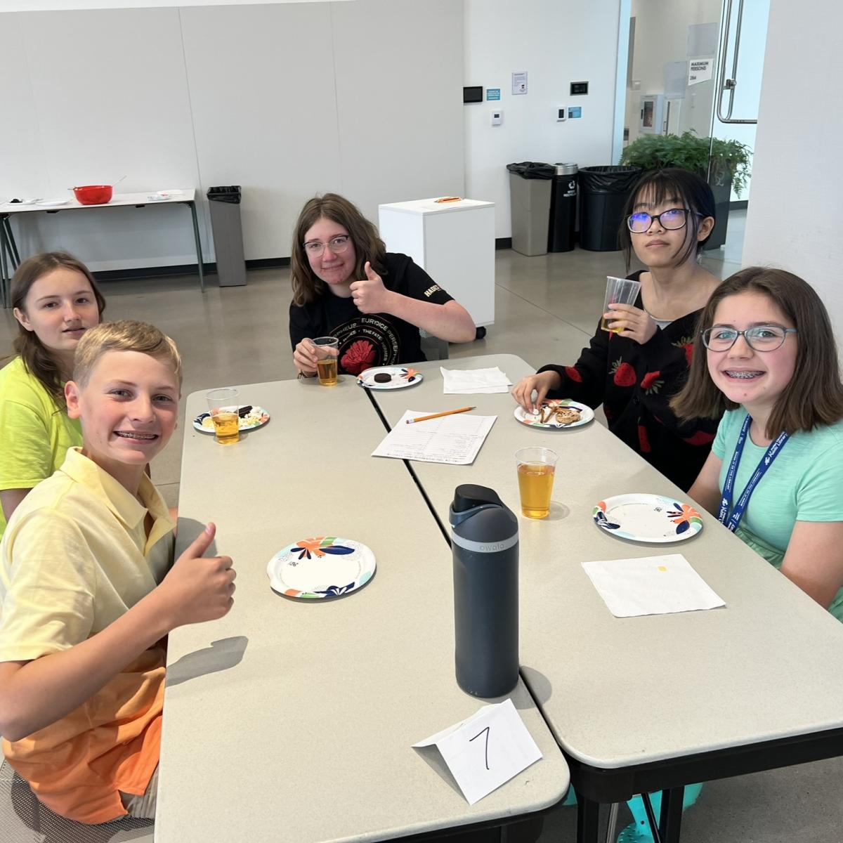 Smiling teens at a table