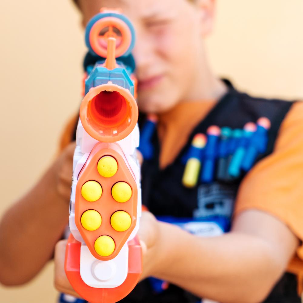 A photograph of a child holding a nerf gun.